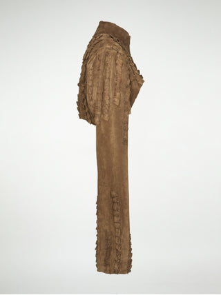 A side view of a brown suede over-bust shrug jacket with long sleeves and strips of pleated leather stitched onto the shoulders and sleeves.