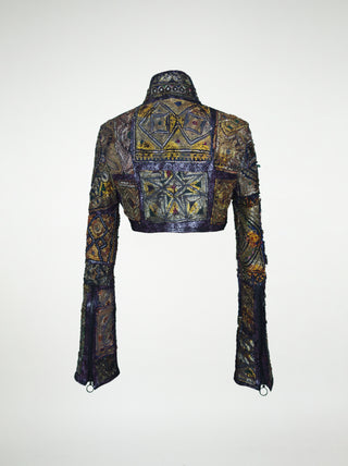 The back view of an over-bust shrug that is encrusted with gold embroidery, mirrors, and silver threads.