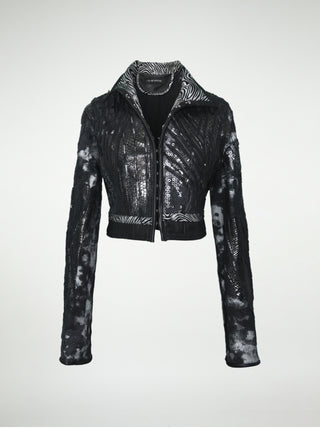 A front view of a black and silver distressed cotton waist-length jacket with overlays of sequins, black lace, metallic embossed leather, and black leather.