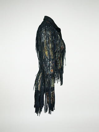 A side view of a black leather jacket with fringes and embellished with antique tapestry and Swarovski crystal rivets.