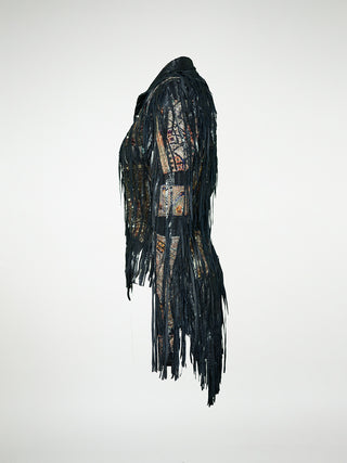 A side view of a black leather jacket with fringes and embellished with antique tapestry and Swarovski crystal rivets.
