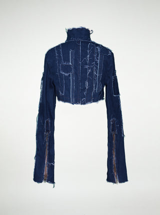 The back of a women's blue denim over-bust shrug with long sleeves and raw edge patchwork.