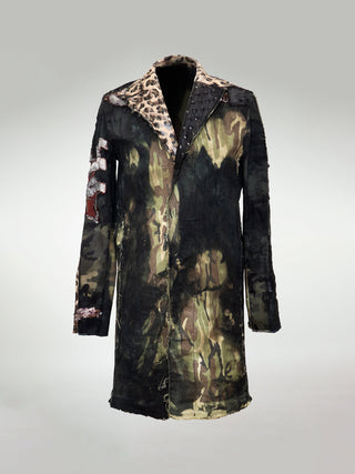 An oversized, boxy camo-print jacket with leather embellishments, antique embroidered appliqué, distressed details, a split notch colour with leopard-print leather and embossed black studded leather panels..