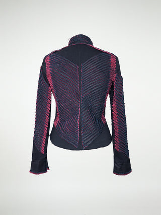 A back view of a fitted black jacket with a chevron pattern, featuring a collar, button details, and a front snap closure.