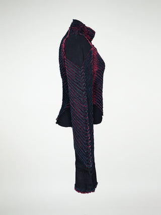 A side view of a fitted black jacket with a chevron pattern, featuring a collar, button details, and a front snap closure.