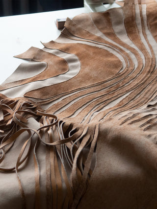 A close up of suede fringe and appliqué