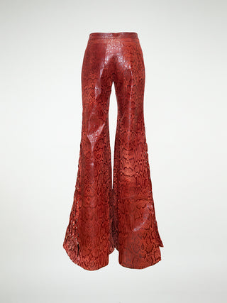 Back view of wide leg leather trousers with woven leather panels and stud embellishments.