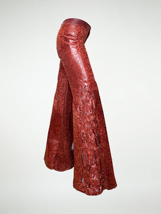 Side view of wide leg leather trousers with woven leather panels and stud embellishments.
