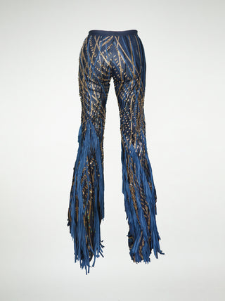 Back view of blue leather fringed pants on a white background