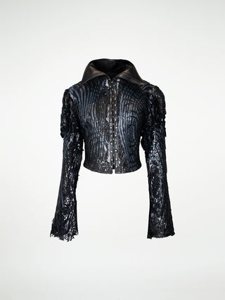 A black metallic leather jacket with lace overlay, gathered leather sleeves, and metal hook and eye closure.