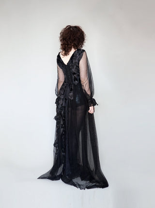 Back of black gown with shear skirt, black french lace, and corseted midriff.