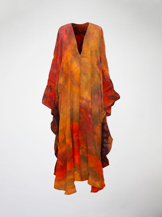 A kaftan style gown in hand-dyed vibrant orange and red silk.