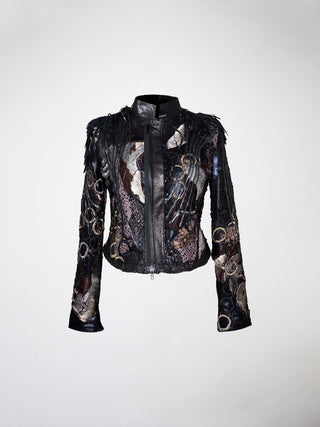 A short black, lavender, silver, and gold jacket with overlays of lace, leather strips, and embroidery. The shoulders have black  fringes.