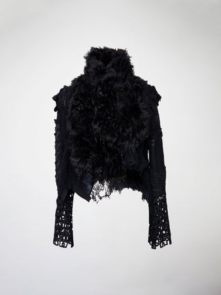 A black wool jacket with a shearling collar and lace sleeves.