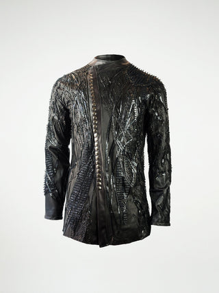 A black stretch leather jacket overlayed with eyelash fringes, studs, and leather strips.