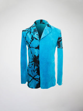 A blue hand-dyed suede blazer with black marbling on the right side.