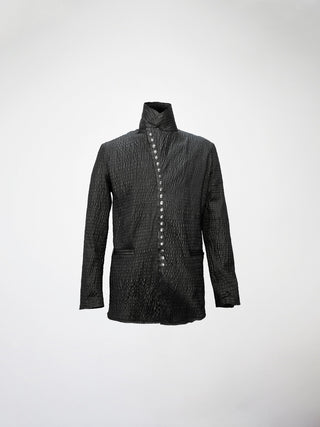 A black gathered leather jacket with welt pockets, a stand collar, and metal snaps down the front.