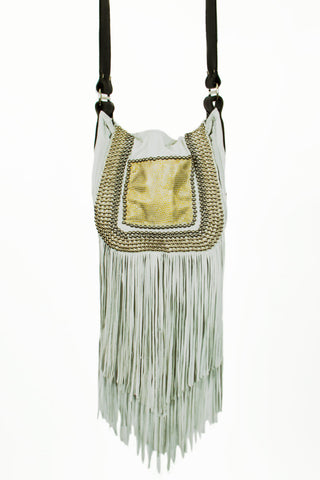 White handbag with gold accents and fringes on a white background