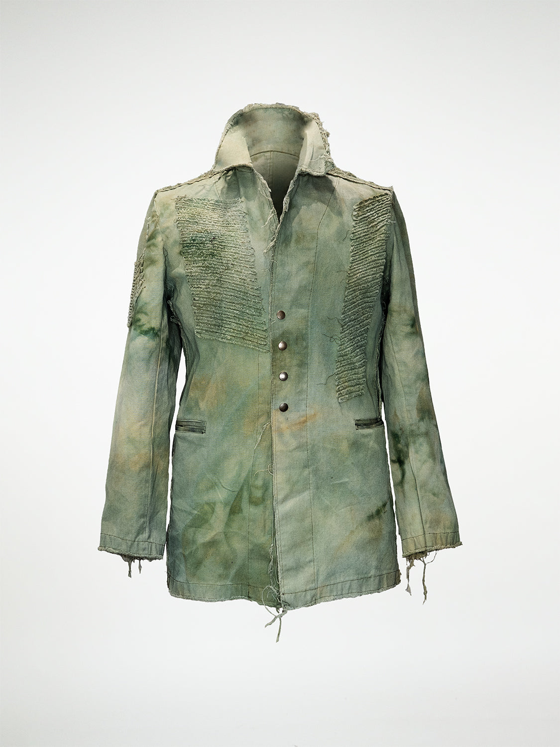 A hand-dyed green linen blazer with raw edge chevron embellishments, raw hems, welt pockets, and metal snaps.