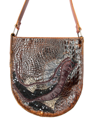Brown leather handbag with textured surface and decorative elements on a white background