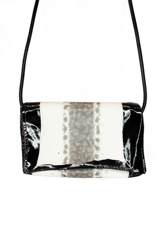 Black and white snakeskin clutch bag on a white background