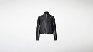 Black leather jacket with panels of gathered leather, pockets, and a statement silver zipper.