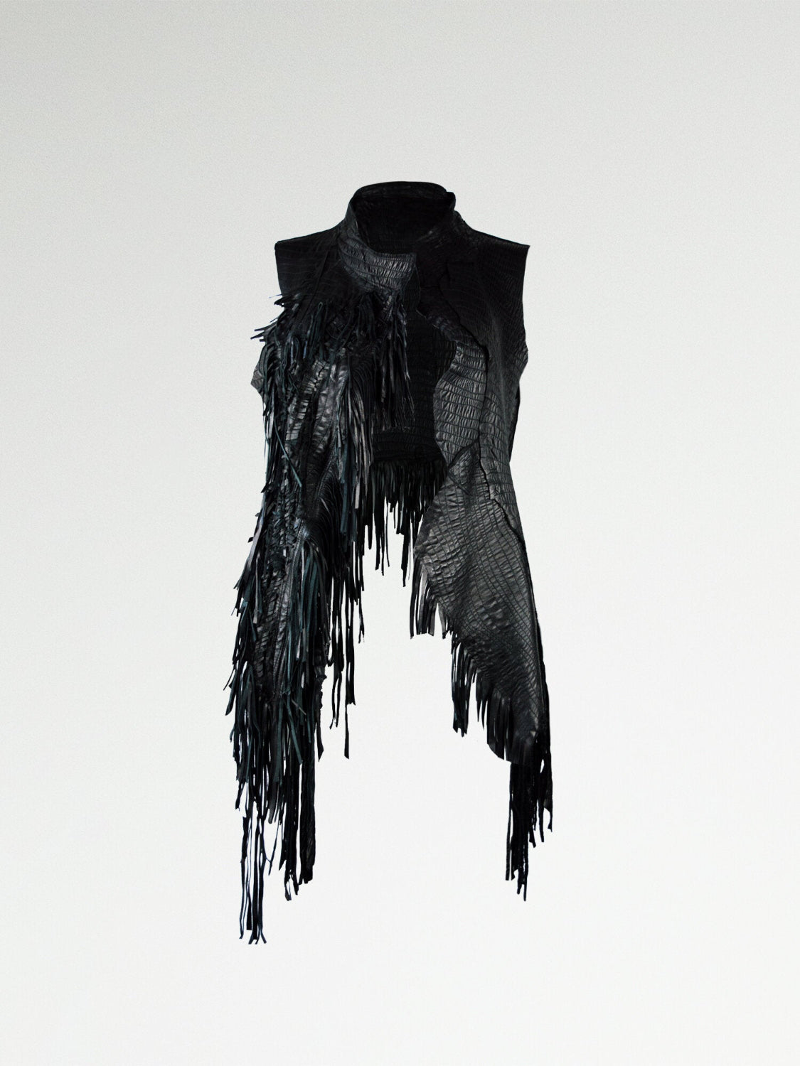 A black gathered leather vest with heavy fringing on one side, irregular paneling, and raw edges.