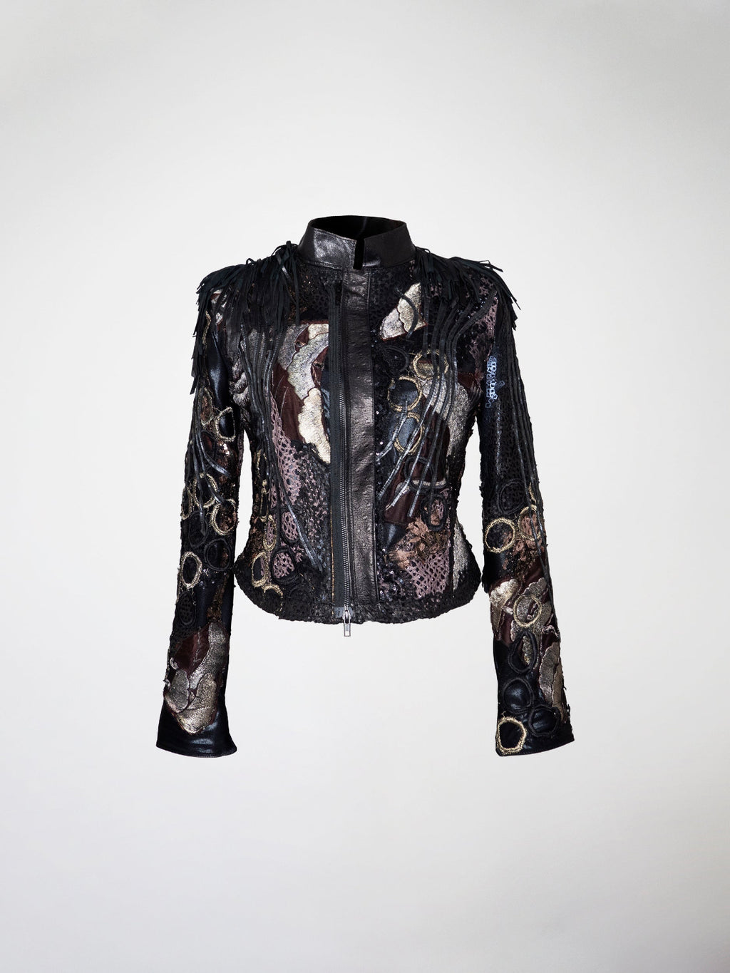 A short black, lavender, silver, and gold jacket with overlays of lace, leather strips, and embroidery. The shoulders have black  fringes.