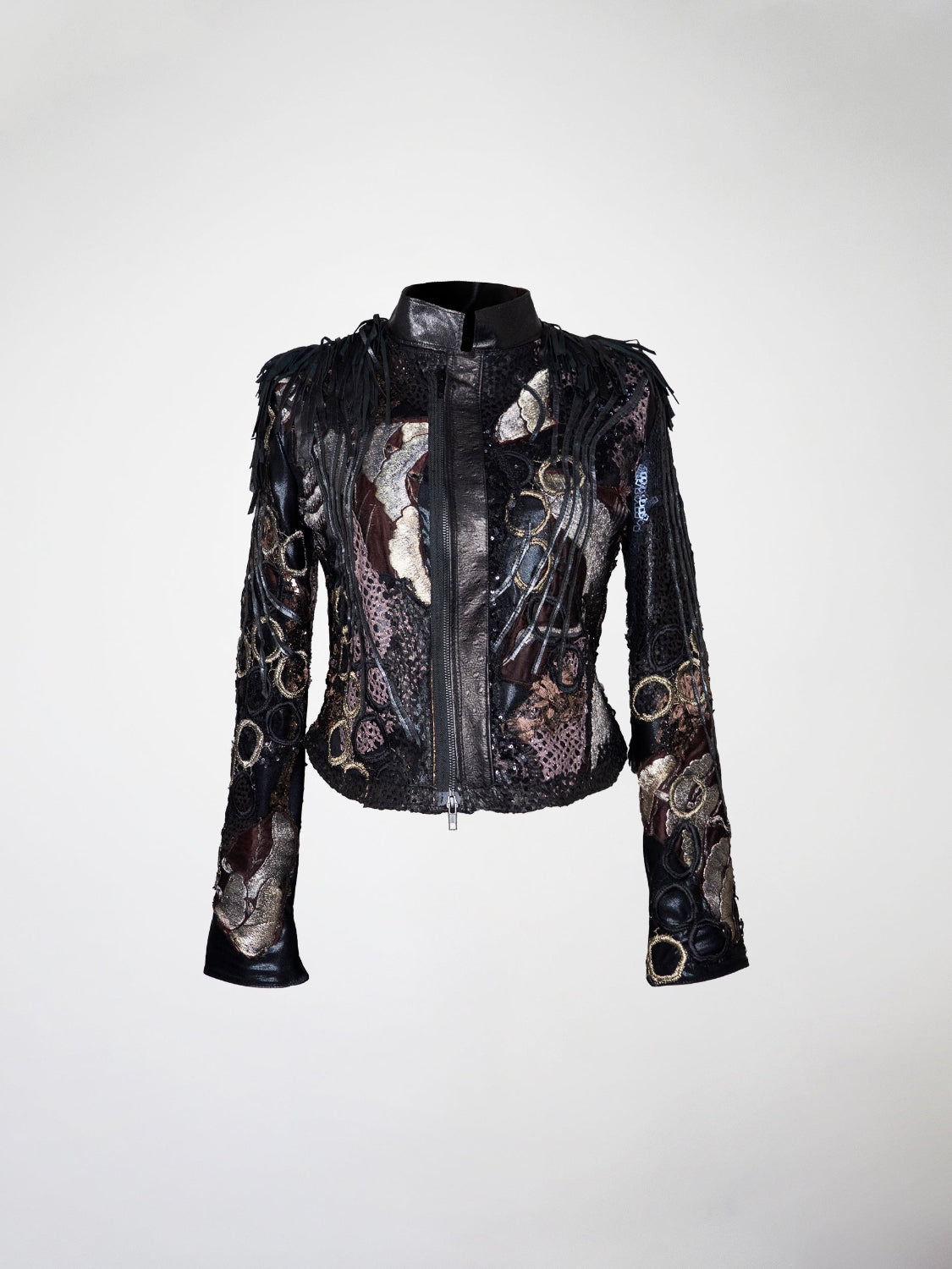 A short black, lavender, silver, and gold jacket with overlays of lace, leather strips, and embroidery. The shoulders have black  fringes.