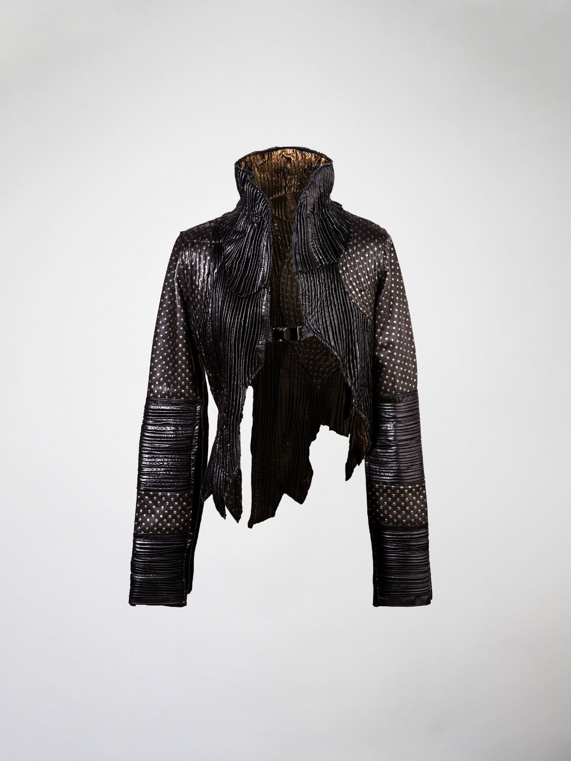 A black leather jacket with pleated details, embossed leather panels, and a metal buckle closure.