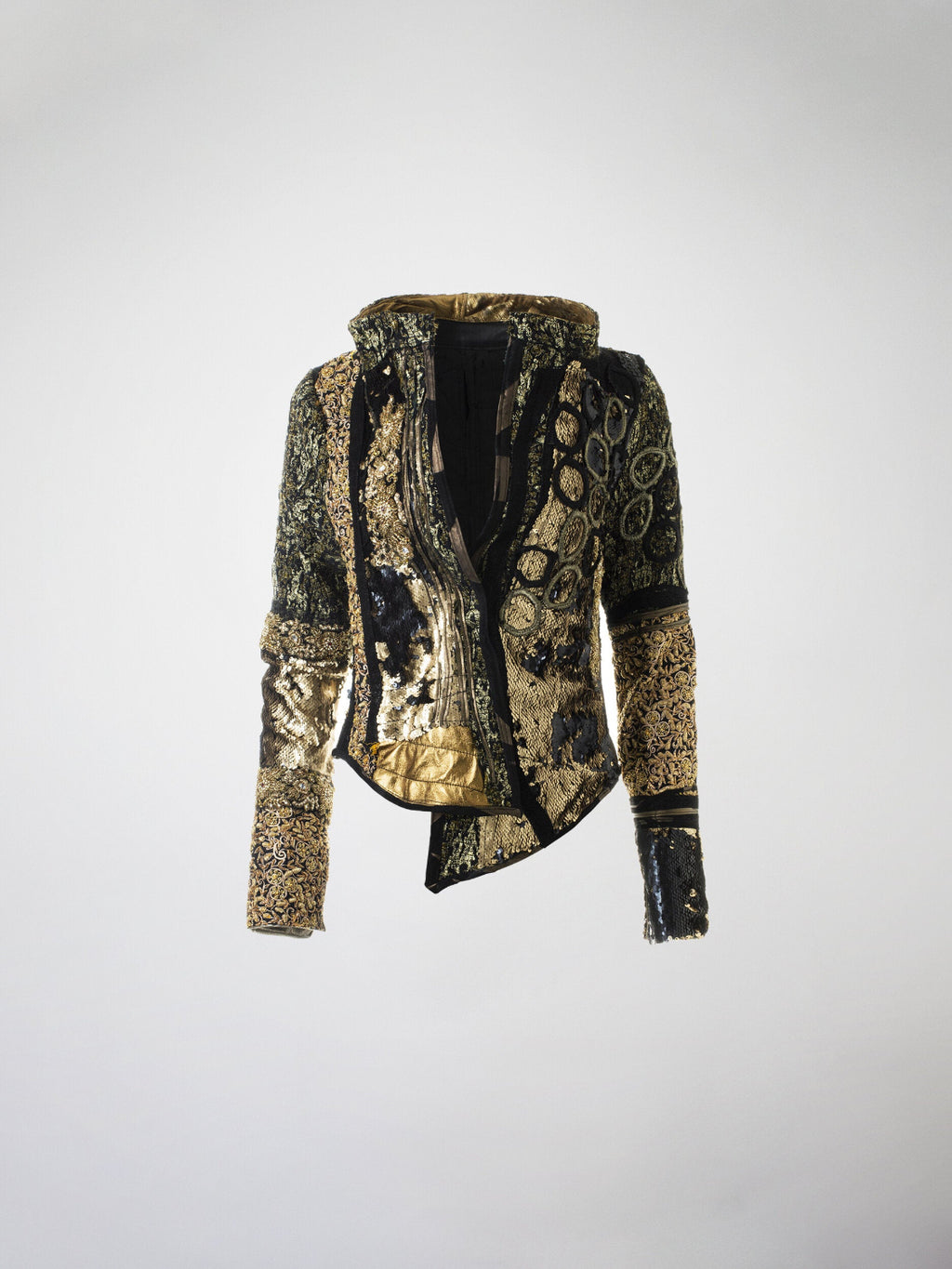 A gold and black mosaic jacket featuring silk brocade, metallic leather, sequins, beaded silk trim, lace, and Swarovski crystal embellishments, with a metal zipper closure.