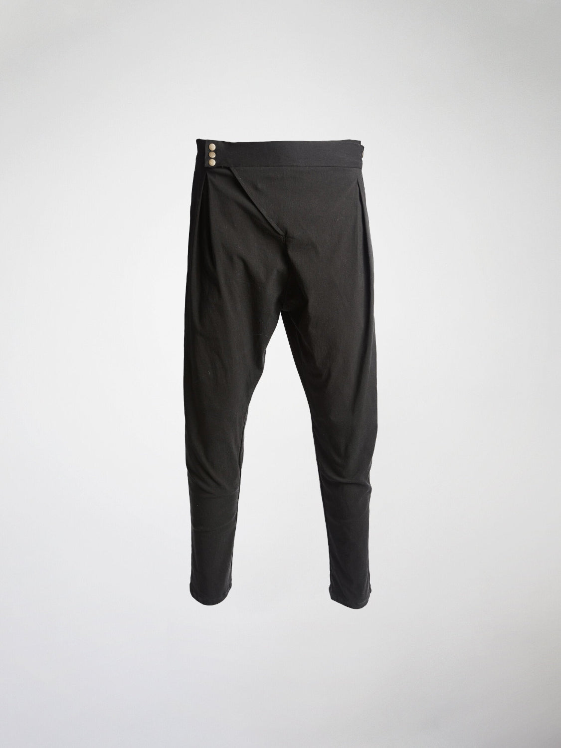 A black drop crotch pant with an asymmetrical fly closure.