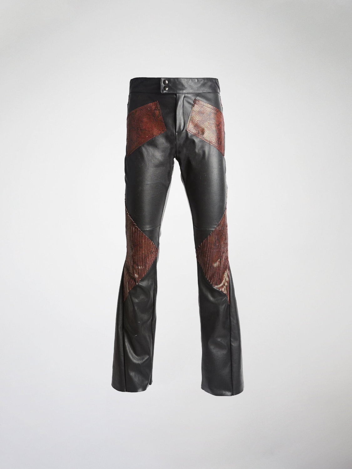 Stretch leather trousers with embossed lamb leather patches and snake print, featuring a 70s boot-cut flare and metal stud embellishments.